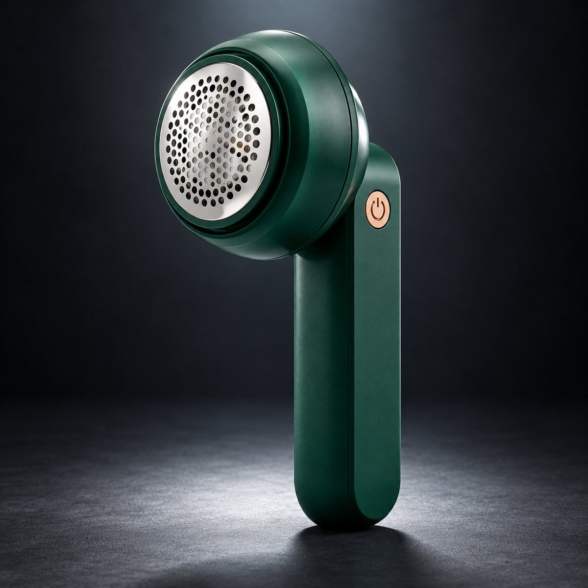 FreshFab electric lint remover, dark green with steel mesh head and rose-gold button